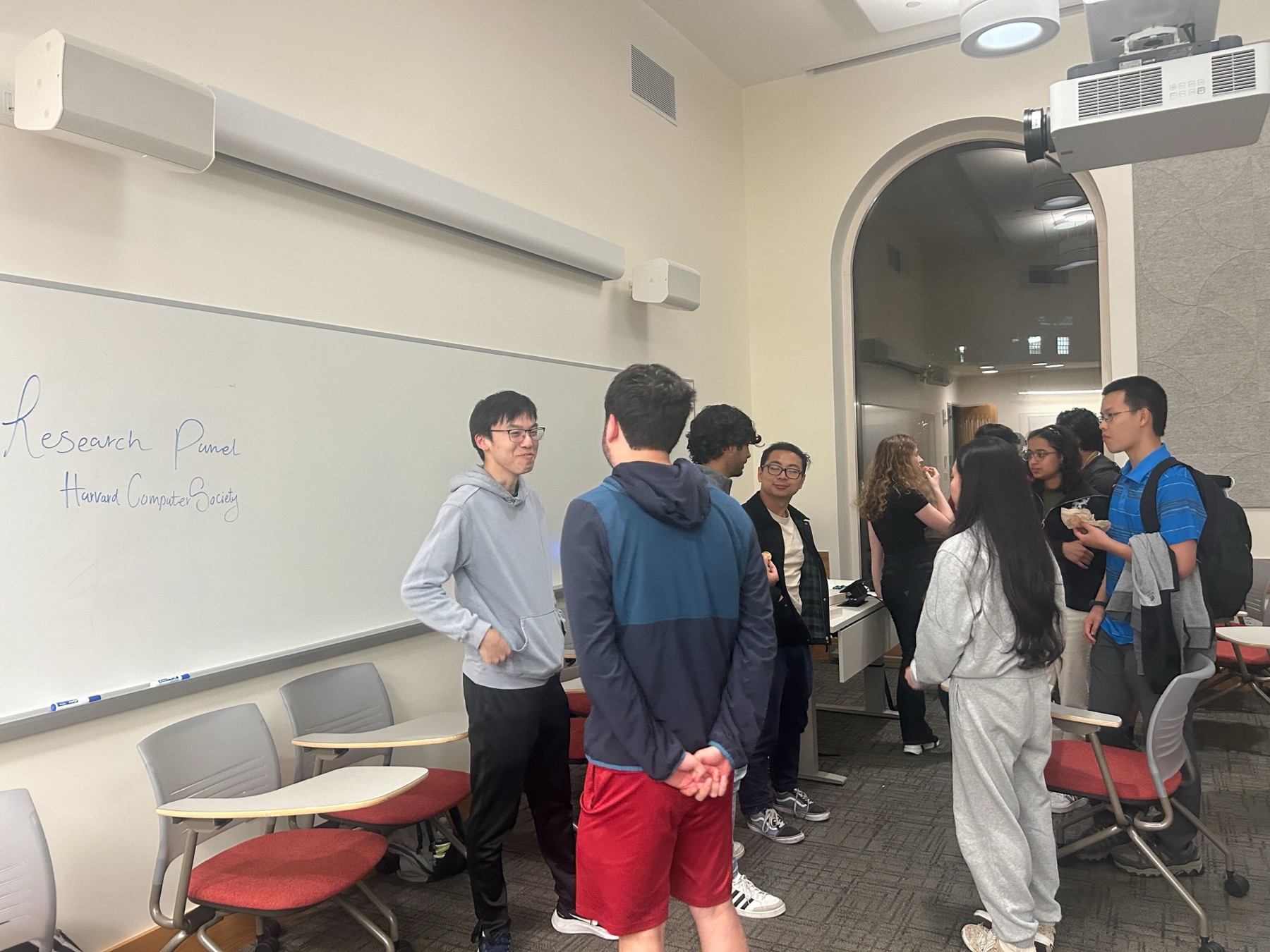 Students and speakers talking after the HCS research panel