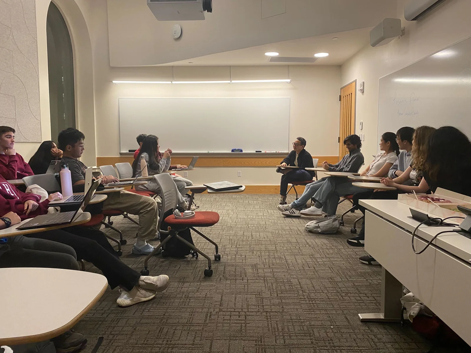 Students speaking with panelists at the HCS research panel